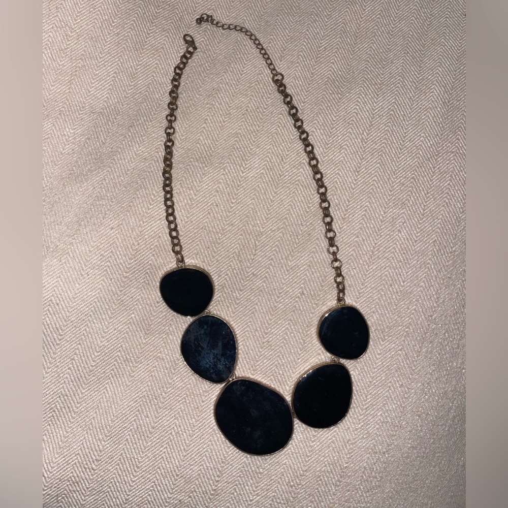 Gold and black necklace.